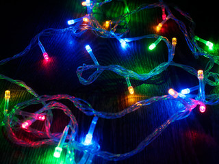 Christmas garland on a dark background. Glowing Christmas garland. New Year and Christmas...