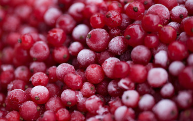 Frozen mixed berries as background. Currant mulberry texture pattern. Diet vegetarian food in winter.