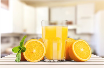 Orange juice and slices of orange on background