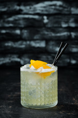 Cocktail Gin tonic with citrus in a glass. On a wooden background. Top view. Free copy space.
