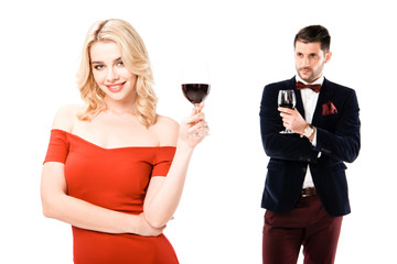 Attractive young couple holding glasses of red wine isolated on white