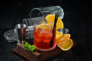 Negroni-Sprits. Alcoholic cocktail in a glass. On a wooden background. Top view. Free copy space.