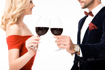 Cropped view of couple clinking glasses of wine isolated on white