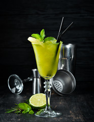 Tropical Green Alcoholic Cocktail. Rum, mint, and pineapple juice. Alcoholic cocktail in a glass....