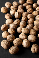 Whole walnuts on black background, side view. Closeup.
