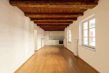 Modern kitchen with parquet and wooden beams.