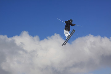 Fototapeta na wymiar Flying skier on snowy mountains. Extreme winter sport, alpine ski. Copy space.