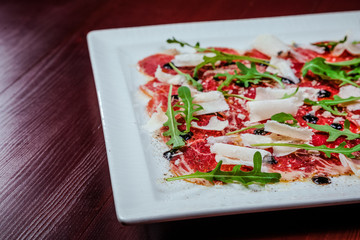 meat carpaccio with arugula
