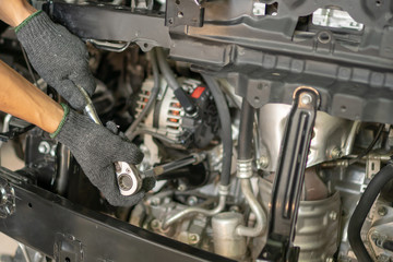 Hand of auto mechanic with a wrench. Car repair