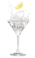 lemon slice falling into a martini cocktail splashing on white background