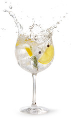 gin tonic garnished with lemon and rosemary splashing on white background