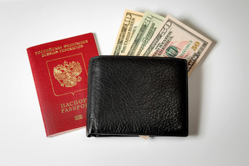 dollar bills in a black men's wallet and a passport of the Russian Federation