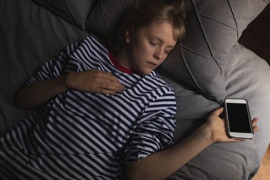 Woman Sleeping On Bed In Bedroom