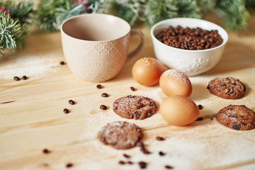 Christmas coffe and cookies on table. Christmas  decorations with lights background. Happy New Year! Christmas greeting card. Winter card template. Xmas concept. Holiday Banner. Feast of Nativity. 