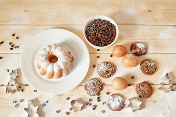 Christmas cake and cookies on table. Christmas  decorations with lights background. Happy New Year! Christmas greeting card. Winter card template. Xmas concept. Holiday Banner. Feast of Nativity. 