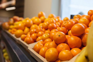 Tangerines and oranges at a showcase in a supermarket