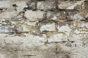 Distressed Weathered Brick Wall with Peeled off Plaster. White Grey Color Shades with Grungy Ragged Texture. Cracked Stained Cement or Stone Surface. Backdrop Template Wallpaper