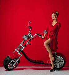 Fototapeta na wymiar Woman pinup style ride new electric car motorcycle bicycle scooter present for new year 2019