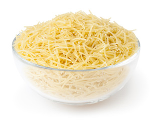 Uncooked vermicelli pasta in glass bowl isolated on white background with clipping path