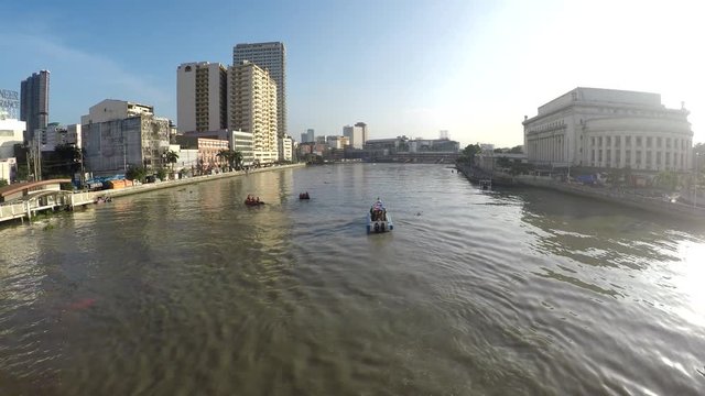 Motorized boat sailing on huge, murky Pasig River early morning