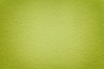 Naklejka na ściany i meble Texture of old green paper background, closeup. Structure of dense light olive cardboard.