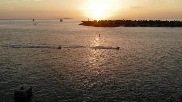 KEY WEST, FL, USA - APRIL 23, 2018: Aerial drone footage made over the ocean to Mallory Square during sunset in Key West