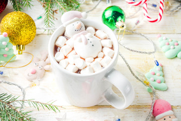 Creative idea for christmas drink, delicious hot chocolate with funny marshmallow snowman, christmas tree, rain dear, santa, on home background with xmas decoration copy space top view