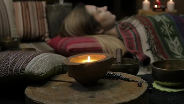 Woman operating with Tibetan singing bowls. yoga instructor conducts meditation. slow motion
