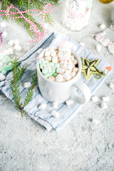 Creative idea for christmas drink, delicious hot chocolate with funny marshmallow snowman, christmas tree, rain dear, santa, on home background with xmas decoration copy space top view