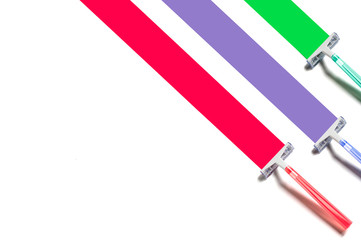Three multi-colored razors leave colored marks