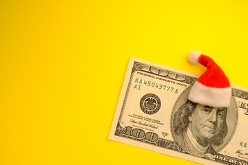 Santa Claus Franklin on the hundred dollar bill USA. The concept of financial expenses for Christmas. Consumption or profit, debt or costs of Americans for the New Year. Copy space.