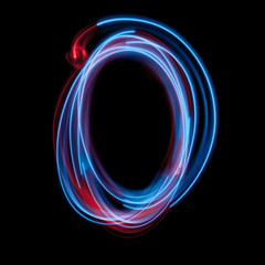 Letter O of the alphabet made from neon sign. The blue light image, long exposure with colored fairy lights, against a black background