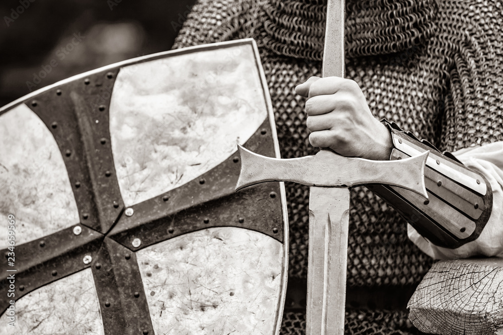 Canvas Prints Closeup view on traditional medieval knight with shield and sword. Image in black and white color style