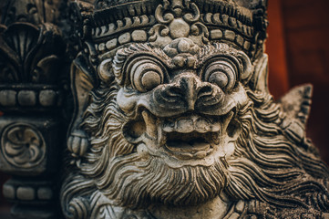 Closeup portrait of Hindu Buddhist traditional stone sculpture. Bali, Indonesia