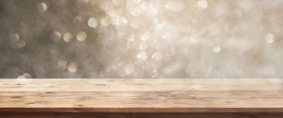Golden bokeh background with wooden table