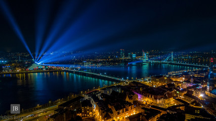 Obraz na płótnie Canvas Panoram of Riga city with blue lights in the sky 