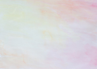 Abstract light watercolor background in pink, yellow and orange with watercolour stains and paper texture.