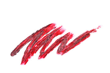 Beautiful red textured lipstick stroke isolated on white.