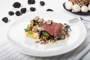 True scented Beef Tenderloin, local true, gratin potatoes, sauteed wild mushrooms, cheese sauce