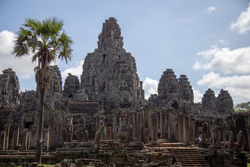 Fototapeta na wymiar Ancient temple name Bayon Angkor with stone faces Siem Reap, Cambodia. Bayon's most distinctive feature is the multitude of serene and smiling stone faces on the many towers 