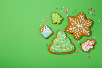 Christmas concept - gignerbread cookies on bright green background
