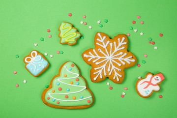 Christmas concept - gignerbread cookies on bright green background