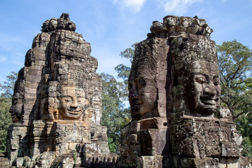Ancient temple name Bayon with stone faces in Angkor Thom, Siem Reap, Cambodia. Bayon's most distinctive feature is the multitude of serene and smiling stone faces on the many towers.