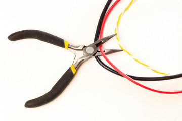 Cutting cable with nippers, on a white background, no isolated, there is toning, close-up.