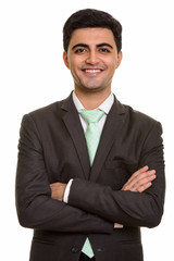 Young handsome Persian businessman looking at camera