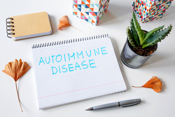Autoimmune disease written in a notebook on white table