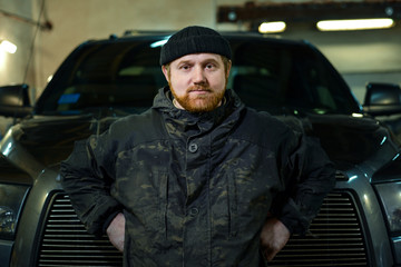 serious man with a red beard on a pickup truck © Olek