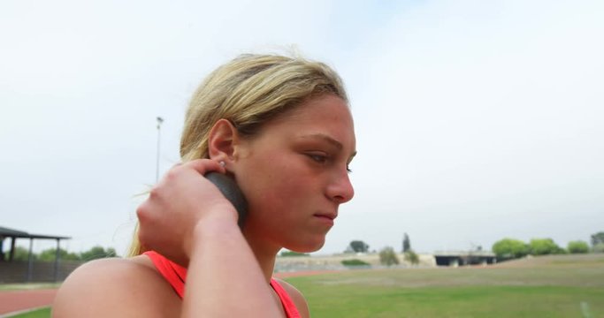 Female athlete getting ready for throw shot put 4k