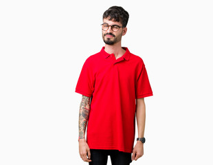 Young handsome man wearing glasses over isolated background winking looking at the camera with sexy...
