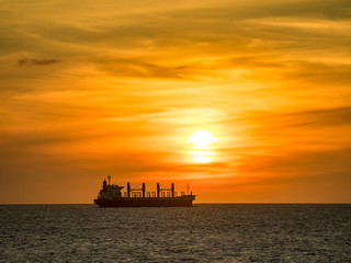A ship sailing past as the sun sets on the Caribbean island of Curacao